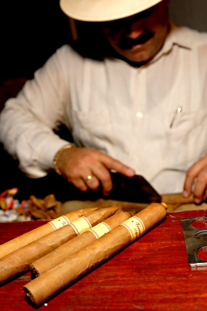 A skilled artisan rolls fine Cuban cigars by hand, showcasing Havanas rich tradition.