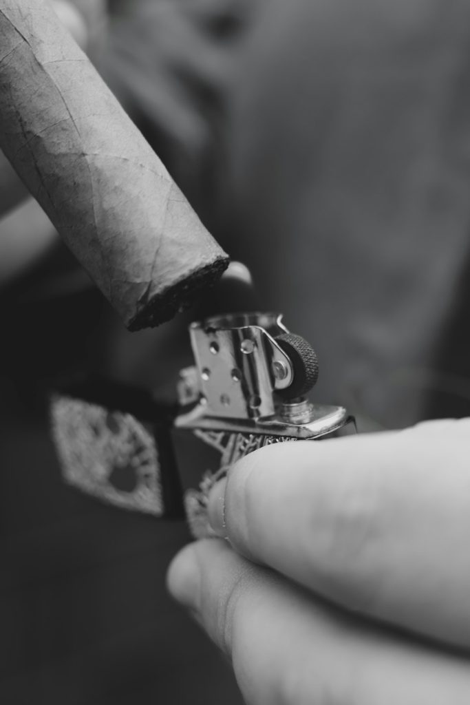 person-lighting-a-cigar-with-a-lighter-ftux5hg1b9m